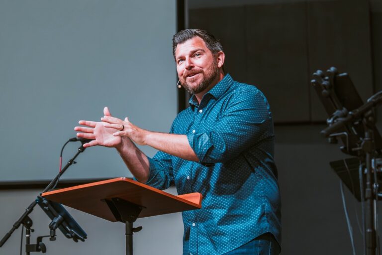 Covenant Church pastor preaching on stage.
